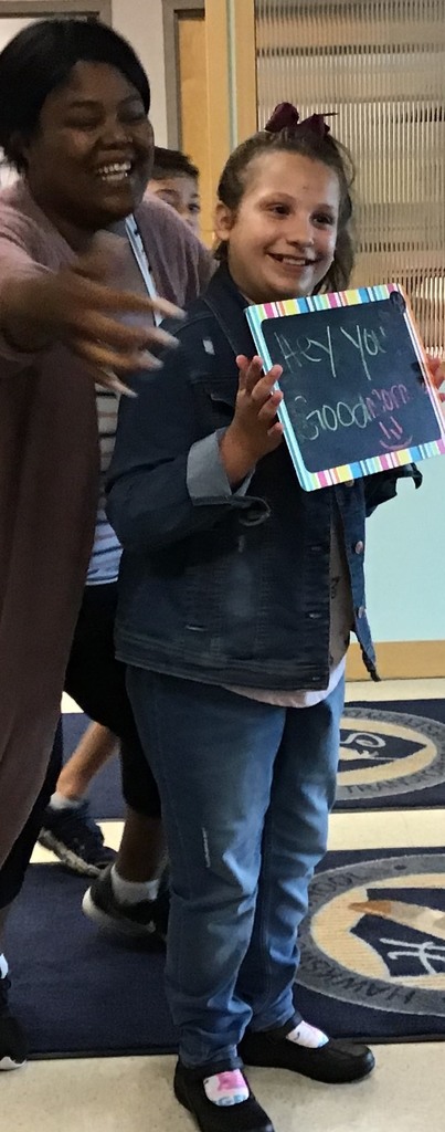 Student holding "Hey You good morning" sign 